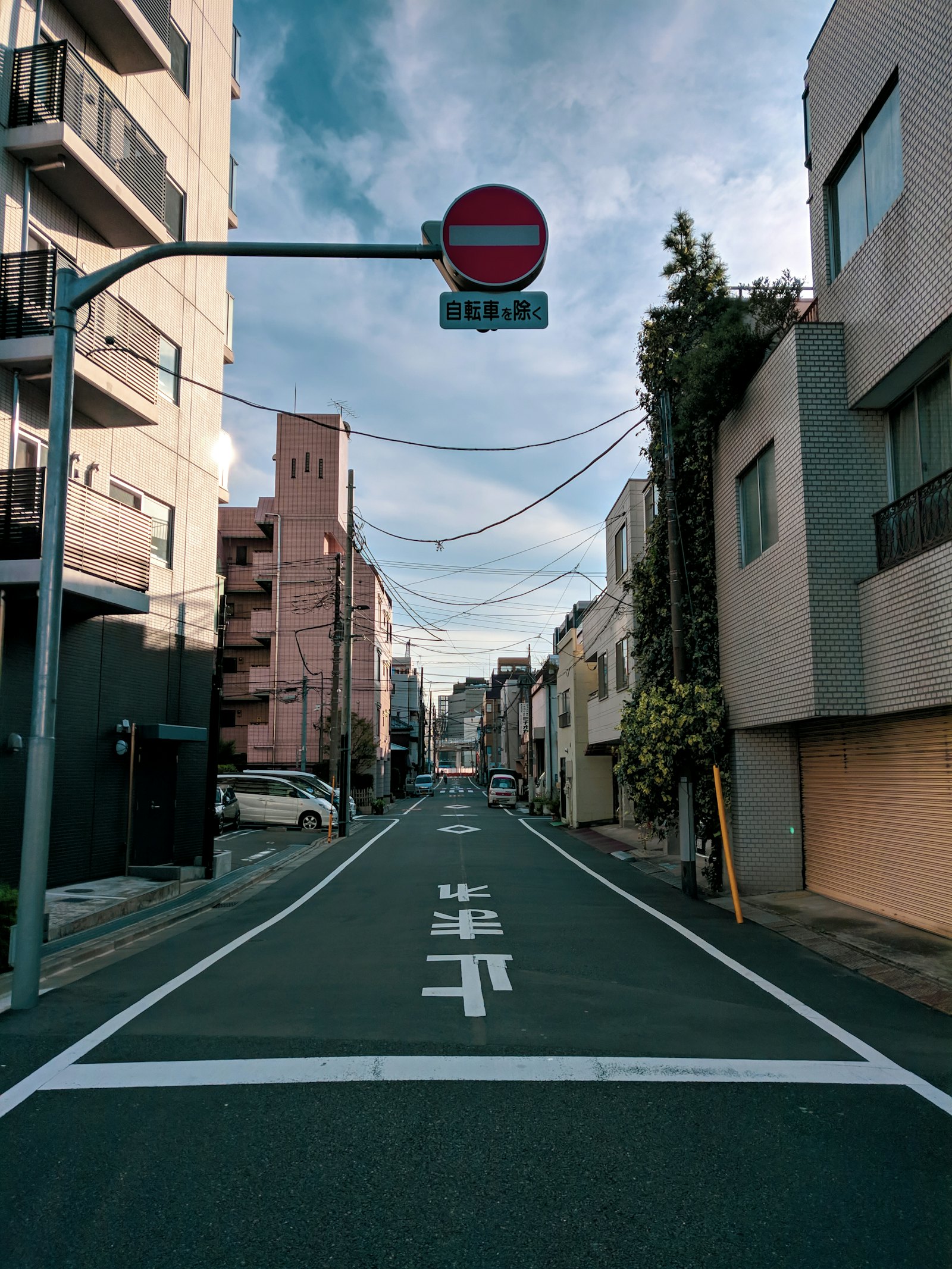 A quiet street with a red no-entry sign
