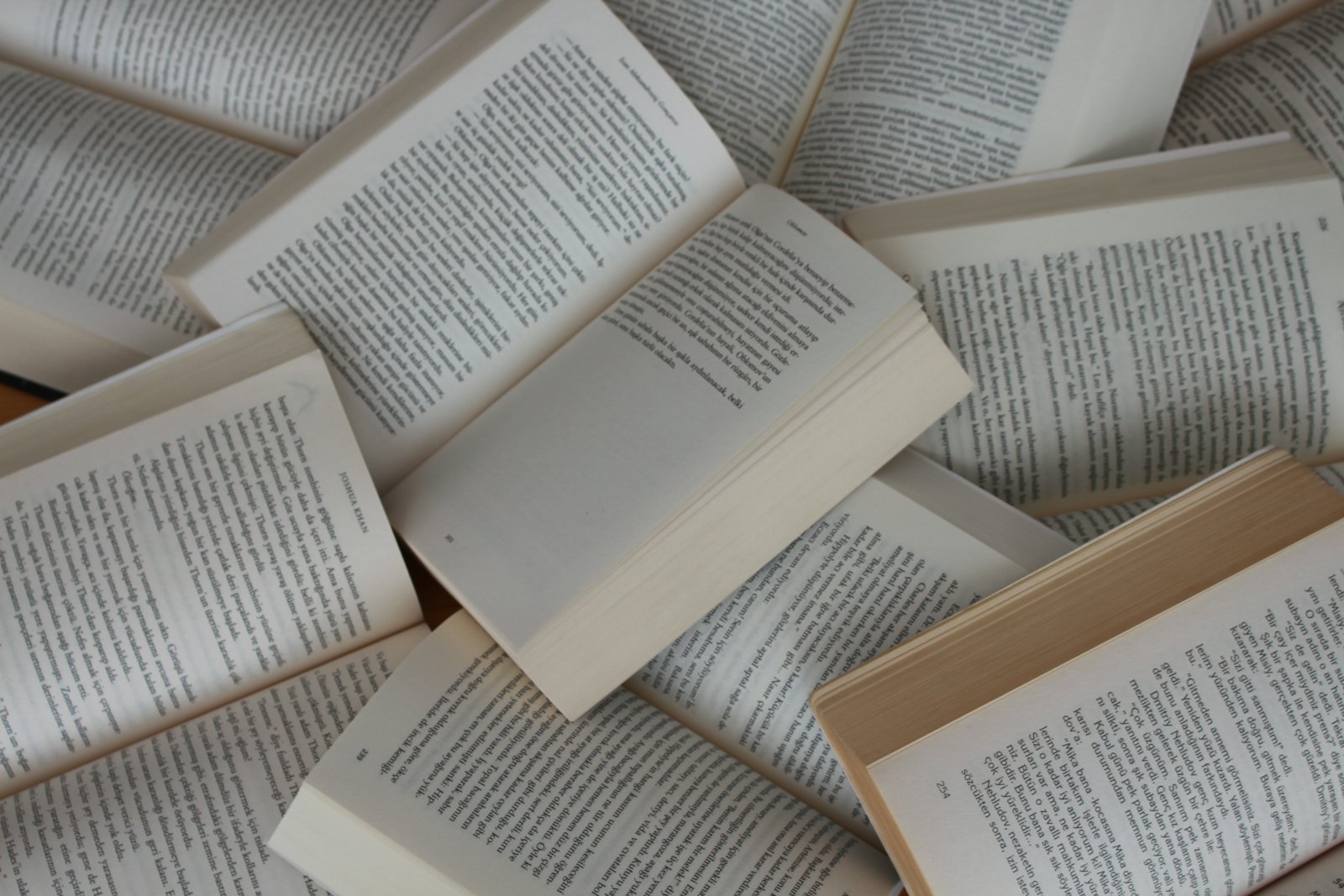 Open books scattered in a pile